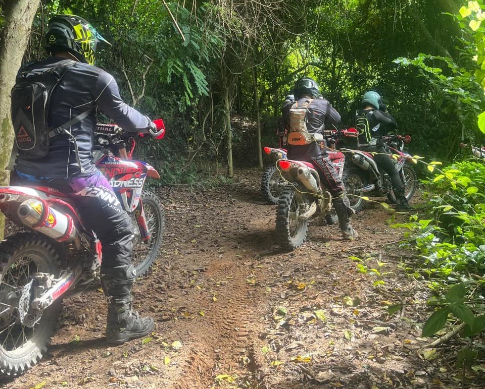 Riders through dense forest trail, Pattaya enduro